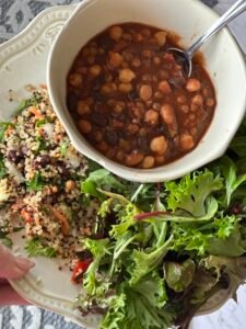 Daniel Fast meal prep plate with three bean chili, quinoa salad, and fresh greens