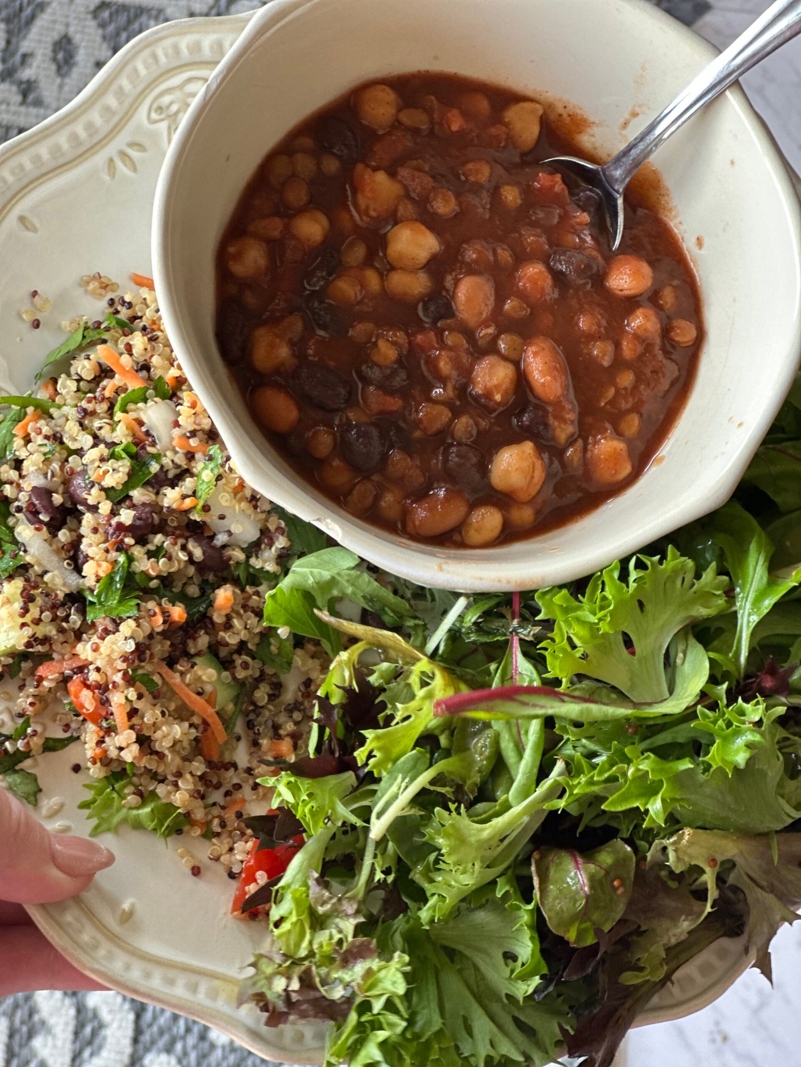 Daniel Fast meal prep plate with three bean chili, quinoa salad, and fresh greens