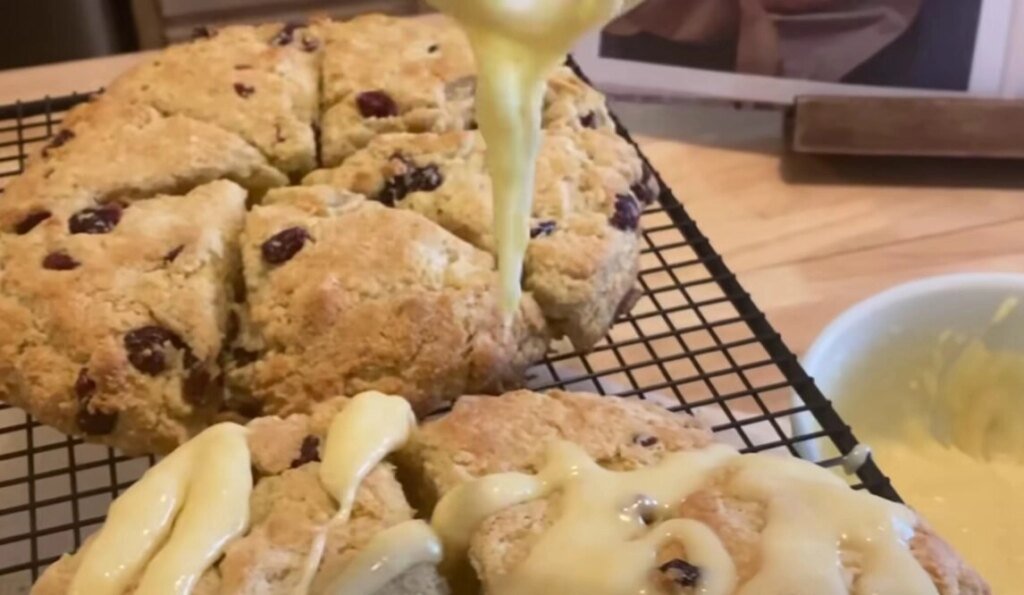 Freshly baked cranberry scones with icing drizzle, symbolizing comfort food and the spiritual root of overeating