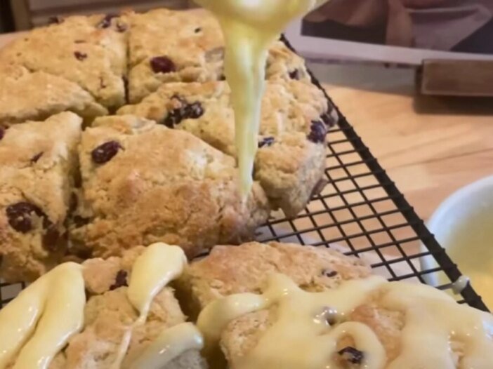 Freshly baked cranberry scones with icing drizzle, symbolizing comfort food and the spiritual root of overeating
